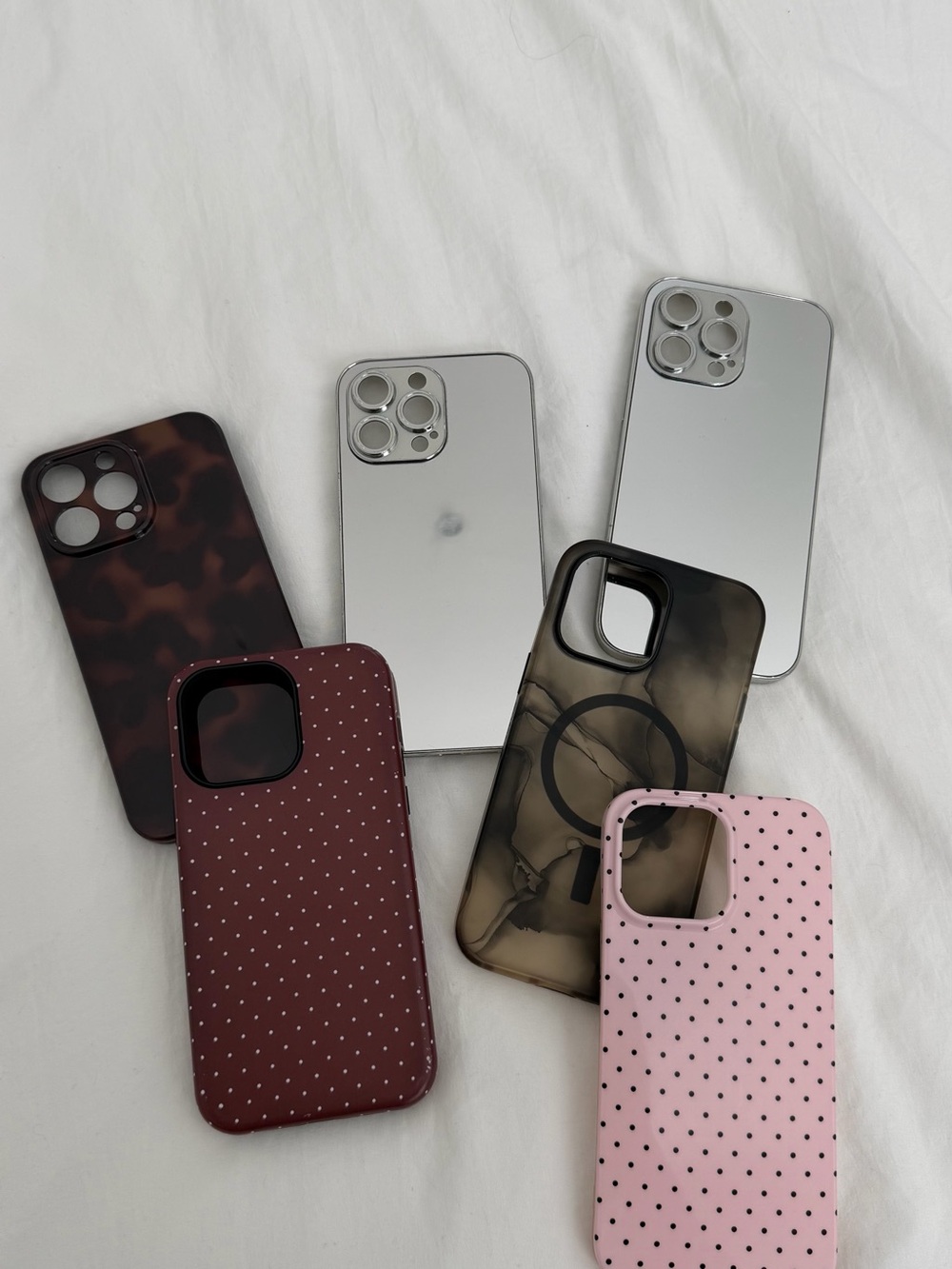Apple iPhone with Silver Mirror Finish and Assorted Protective Cases